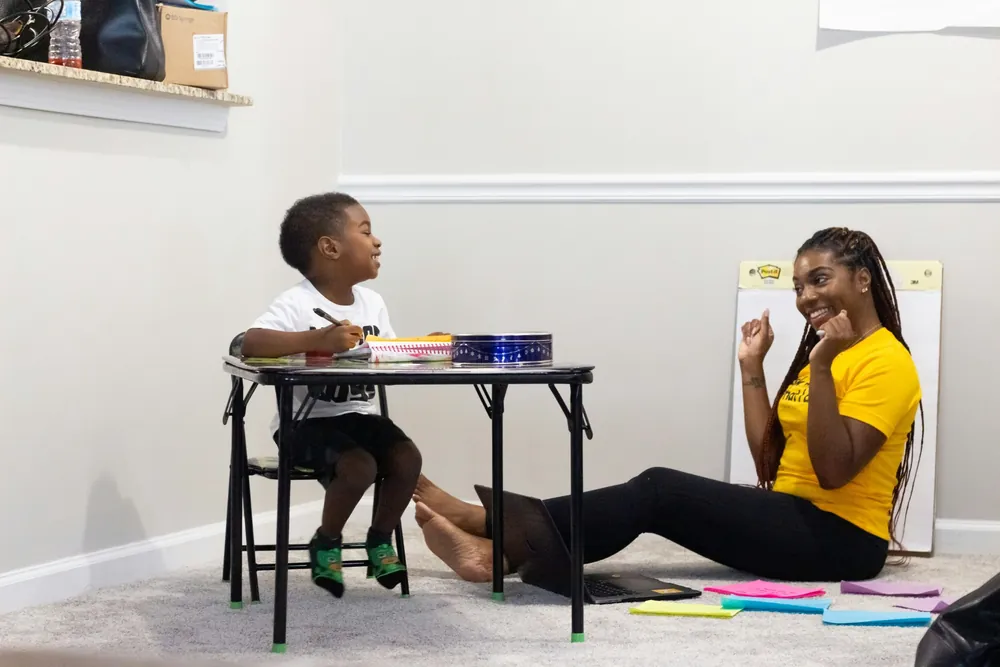 An adult and child doing a hands-on learning activity together